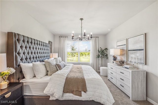 bedroom with a chandelier and light colored carpet