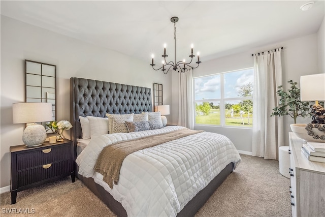 carpeted bedroom featuring a chandelier