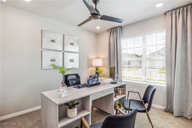 carpeted office with ceiling fan and plenty of natural light