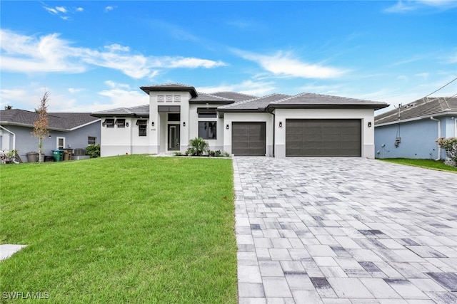 prairie-style house with a garage and a front yard