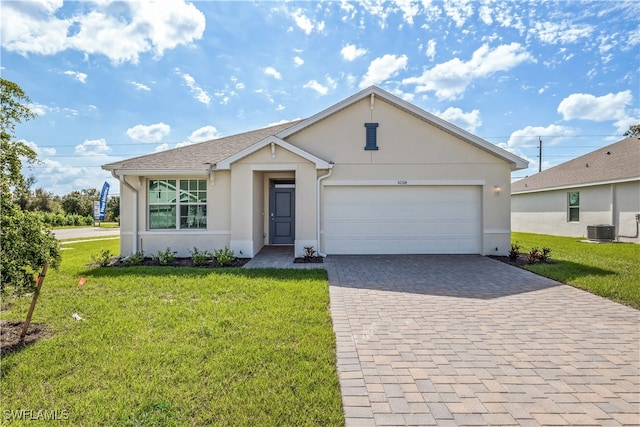 ranch-style home with cooling unit, a garage, and a front yard