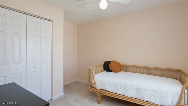 carpeted bedroom featuring a closet and ceiling fan