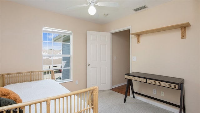 bedroom featuring light carpet and ceiling fan