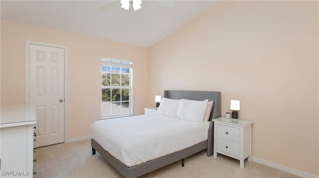 bedroom featuring lofted ceiling, ceiling fan, and light colored carpet