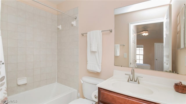 full bathroom featuring shower / bath combo, vanity, toilet, and ceiling fan