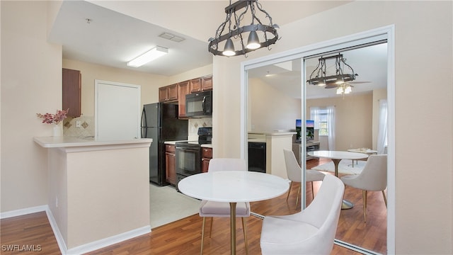 dining area with hardwood / wood-style floors and ceiling fan