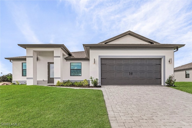 view of front of home with a garage and a front yard