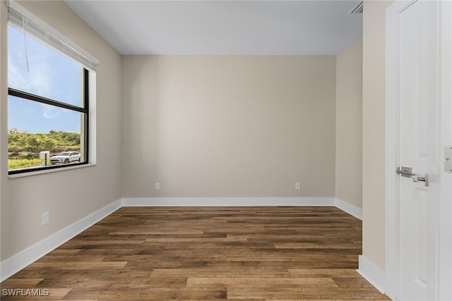 empty room with dark hardwood / wood-style floors