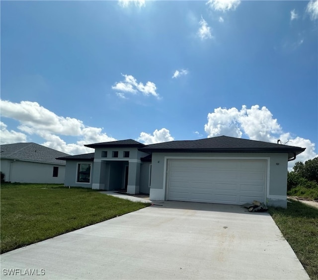 view of front of property with a garage and a front lawn