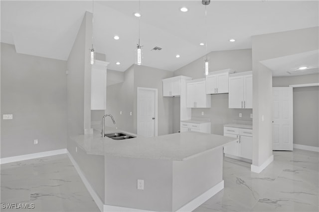 kitchen featuring kitchen peninsula, sink, white cabinets, and hanging light fixtures