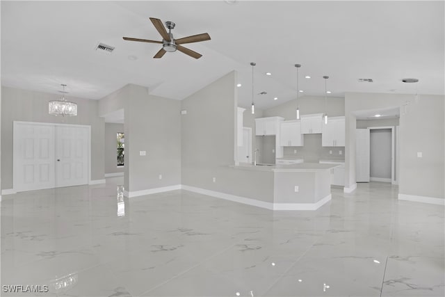 unfurnished living room with ceiling fan with notable chandelier, sink, and vaulted ceiling