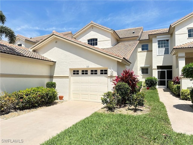 view of front of house with driveway, an attached garage, a tiled roof, and stucco siding