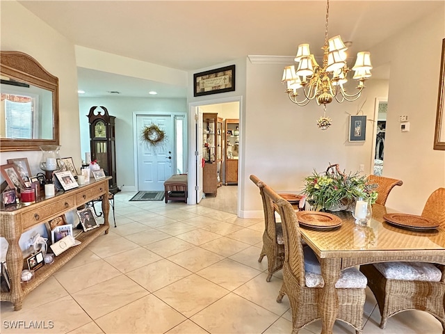 dining space featuring light tile patterned floors and a chandelier