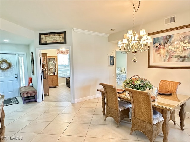 dining space with crown molding, light tile patterned floors, and a notable chandelier