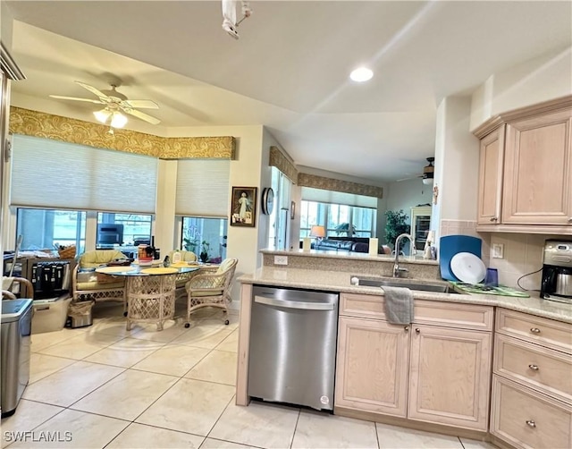 kitchen featuring a wealth of natural light, open floor plan, dishwasher, and a sink