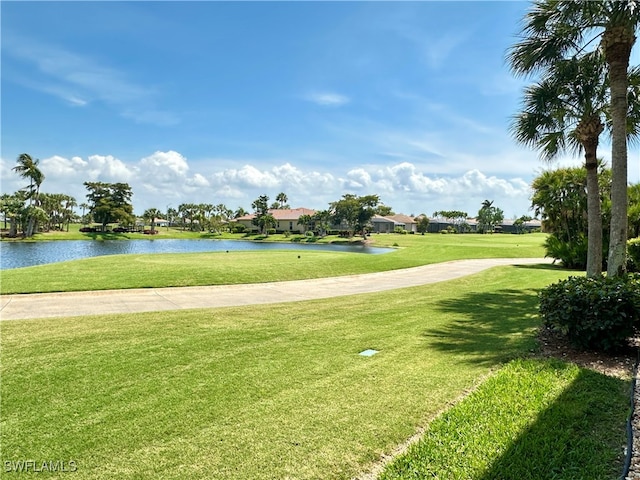 view of home's community with a lawn and a water view