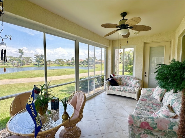 sunroom with a water view and ceiling fan