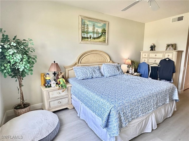 bedroom with visible vents, ceiling fan, baseboards, and wood finished floors