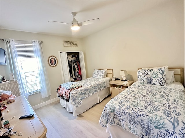 bedroom with ceiling fan, light wood-type flooring, and a closet