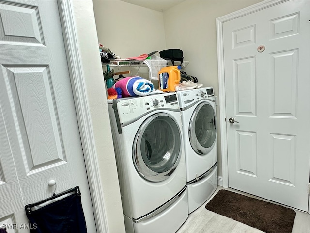 washroom featuring light hardwood / wood-style flooring and washer and dryer