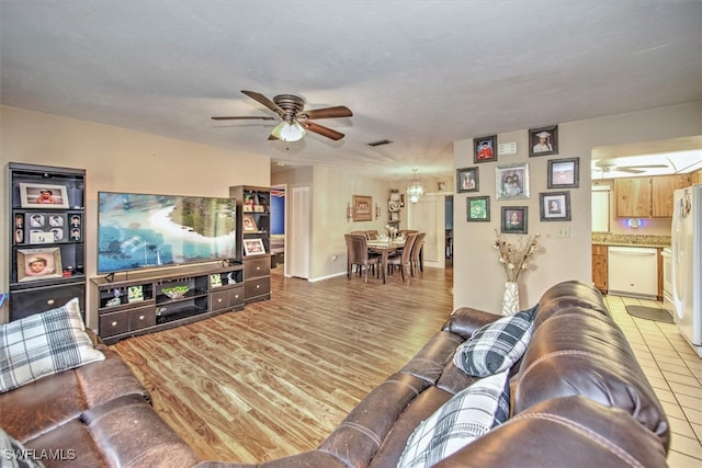 living room featuring ceiling fan and light tile patterned floors