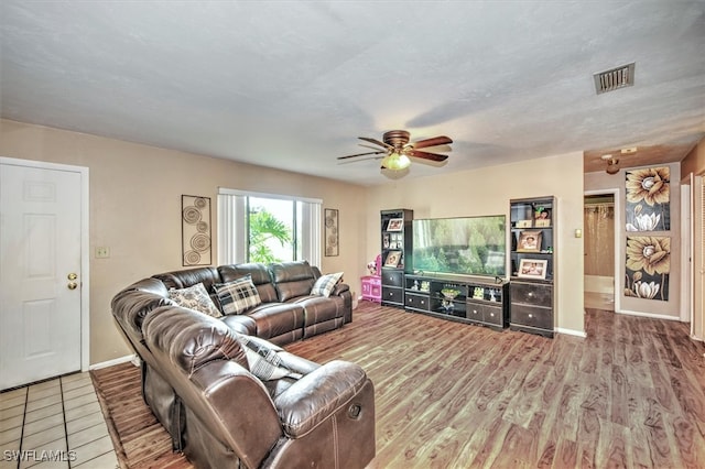 living room featuring ceiling fan and hardwood / wood-style flooring