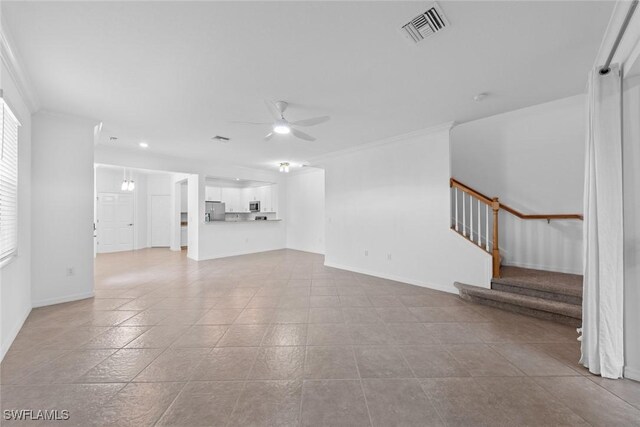 unfurnished living room featuring ornamental molding, light tile patterned flooring, and ceiling fan