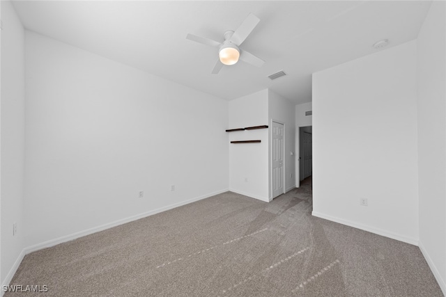 carpeted spare room featuring ceiling fan