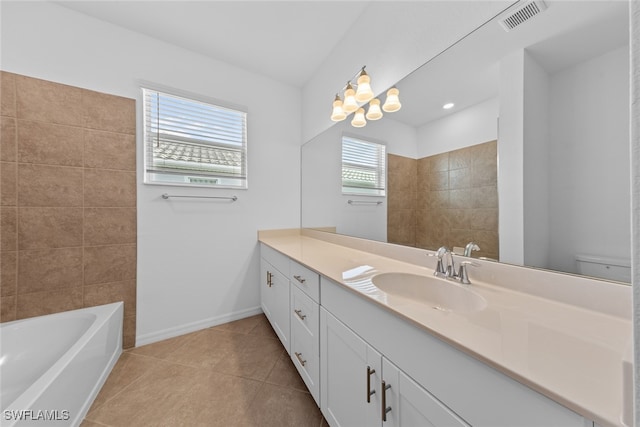 bathroom with a bath, tile patterned flooring, toilet, and vanity