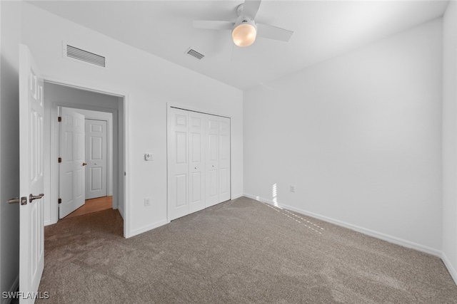 unfurnished bedroom featuring carpet, ceiling fan, and a closet