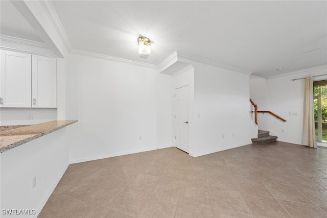 unfurnished living room with crown molding