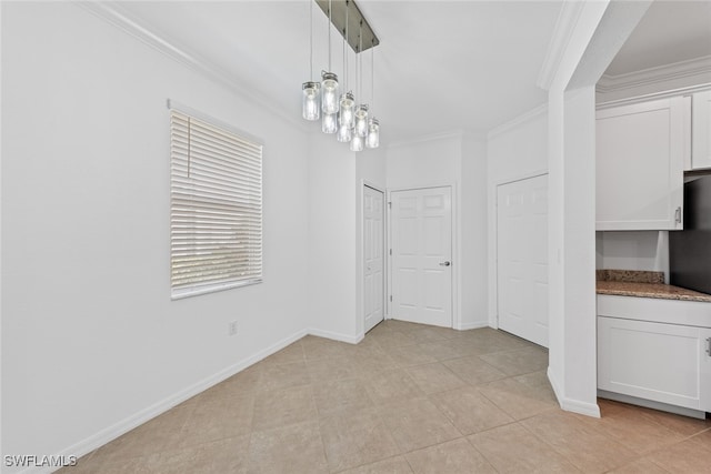 unfurnished dining area with ornamental molding and light tile patterned floors