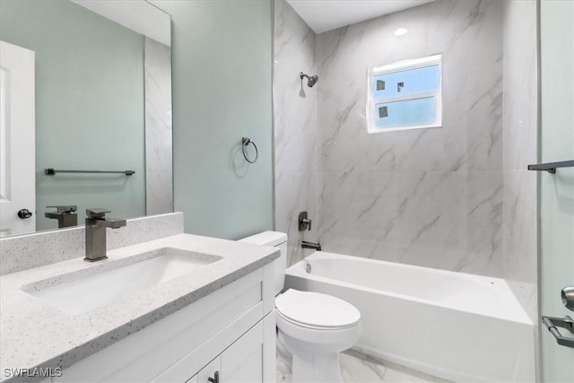 full bathroom featuring tiled shower / bath combo, vanity, and toilet