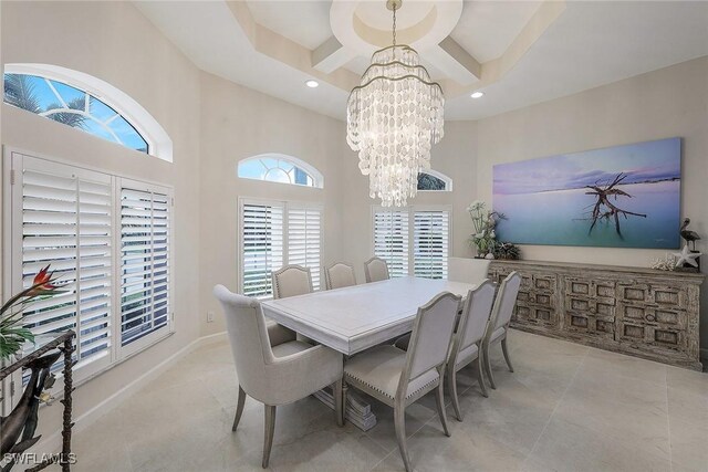 dining space featuring a high ceiling and a notable chandelier