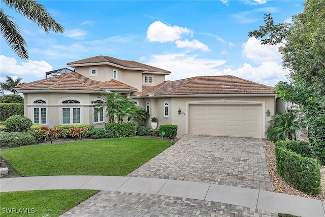 mediterranean / spanish-style house with a front yard and a garage