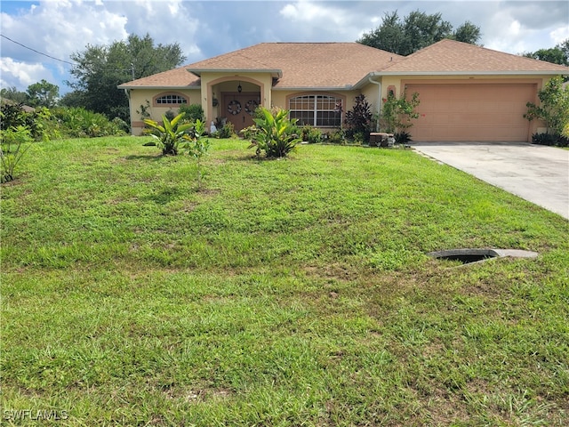 view of front of house featuring a garage and a front yard