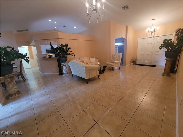 tiled living room featuring a chandelier