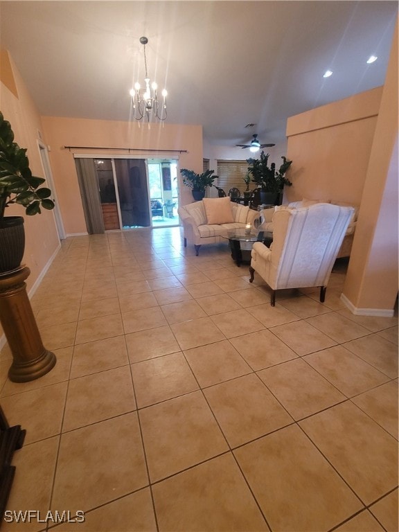 living room featuring ceiling fan with notable chandelier and light tile patterned flooring