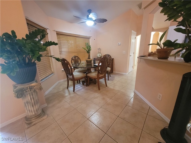 dining space with ceiling fan and light tile patterned flooring