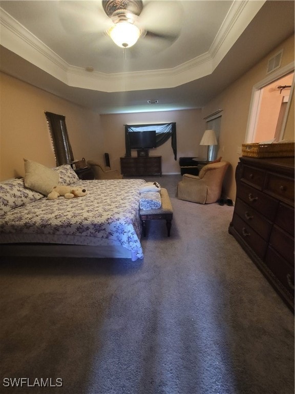 carpeted bedroom featuring ornamental molding, a raised ceiling, and ceiling fan