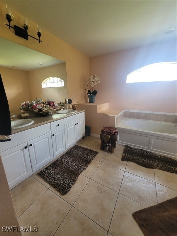 bathroom featuring tile patterned flooring, vanity, and a bathtub