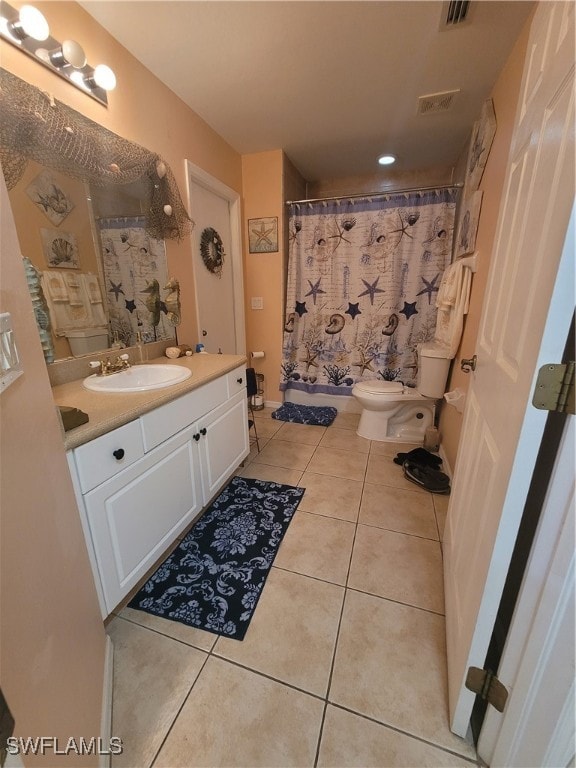 bathroom featuring vanity, toilet, a shower with shower curtain, and tile patterned flooring