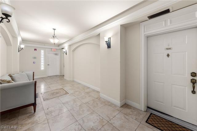 entrance foyer featuring ornamental molding