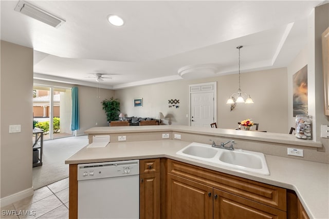 kitchen featuring pendant lighting, white dishwasher, sink, light colored carpet, and an inviting chandelier