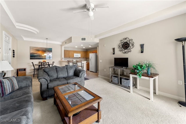 carpeted living room with ceiling fan