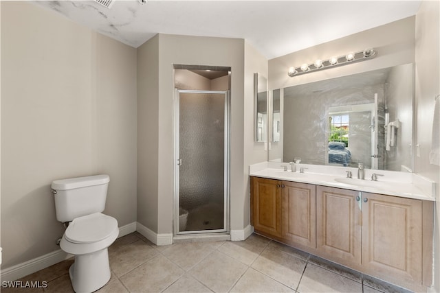 bathroom featuring vanity, tile patterned floors, an enclosed shower, and toilet