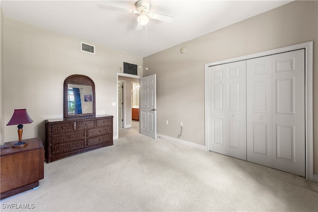 bedroom with ceiling fan, light colored carpet, and a closet