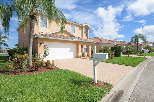 mediterranean / spanish-style home with a garage and a front yard