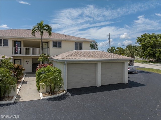 view of front of property featuring a balcony and a garage