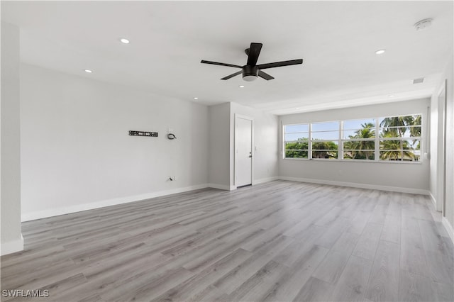 spare room with ceiling fan and light wood-type flooring